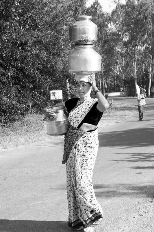 Women and Drinking Water Challenges - Carrying multiple drinking water containers from a distant tapstand in a village in district Ahmednagar, Maharashtra